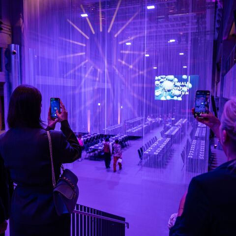 Networking area with purple lighting at a conference in the JED Events hall.